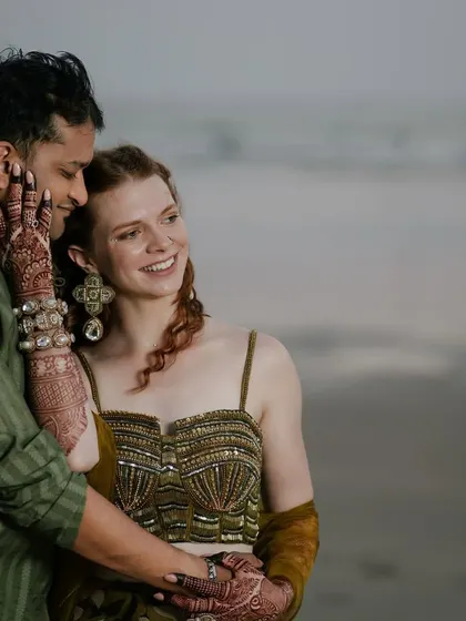 For their bohemian beach sundowner, we styled the couple in earthy tones. This intimate shot shows the intricate seashell-inspired embroidery on her corset blouse and the texture of his olive green kurta.