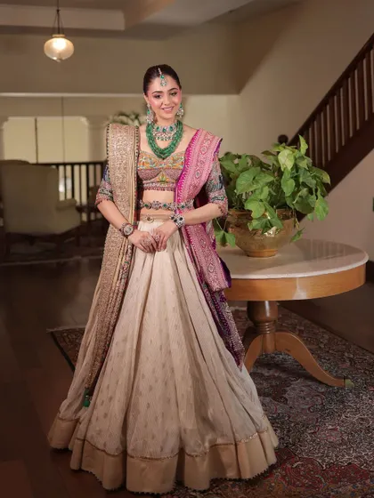 The bride looks happy and confident in this unique ensemble, which perfectly blends traditional crafts with a modern silhouette.