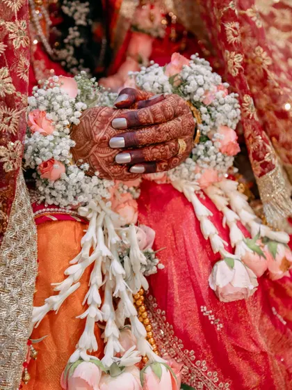 The beauty is in the details. This close-up from a Muslim wedding highlights the intricate henna, floral garlands, and traditional attire that make each celebration unique.