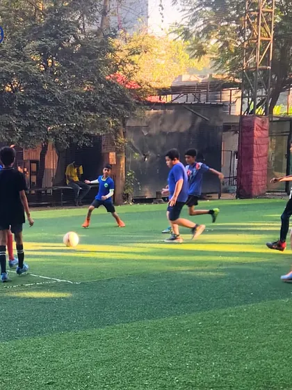 A dynamic moment from a football practice match. Our players are seen moving the ball up the field, showcasing the teamwork and fluid play we encourage.
