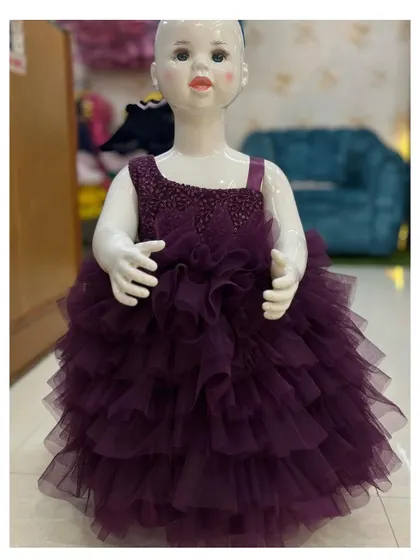 This purple frills gown has a sparkly, beaded bodice and a very full, multi-layered skirt.