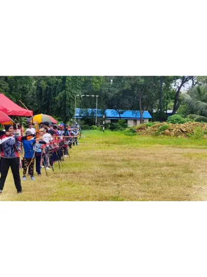 A wide view of the shooting line at the regional competition, with archers of all ages participating under the watchful eyes of coaches and officials.