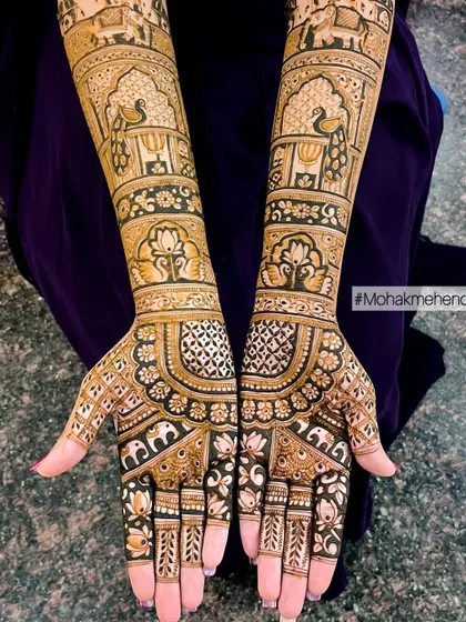 A classic and regal bridal design featuring peacocks, elephants, and lotuses. The use of negative space and bold outlines gives this traditional Rajasthani style a clean and striking appearance.