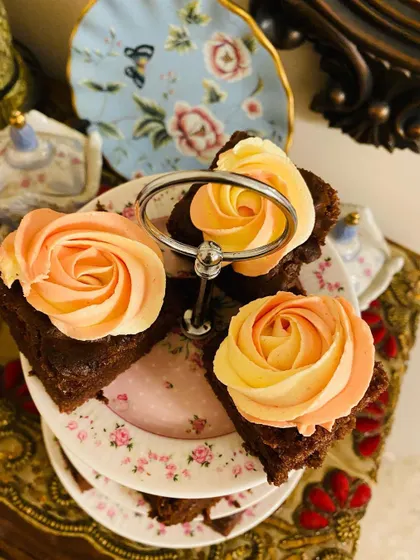 A top-down view of my chocolate cake squares, each decorated with a lovely dual-toned buttercream rosette. Perfect for dessert tables.