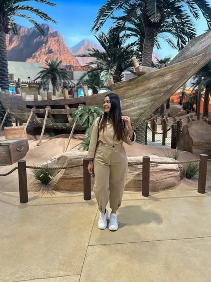 Another view of the versatile beige jumpsuit, a perfect choice for a day of adventure.
