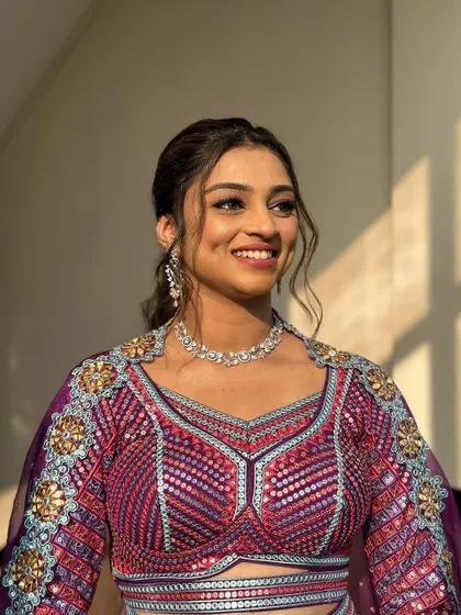 This look is all about fun and glamour. The high, curly ponytail is perfect for a vibrant Sangeet night.