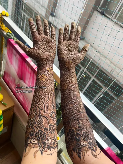 A complete bridal mehendi look, with intricate details covering the hands and arms. This level of detail is what makes a bridal design truly stand out.