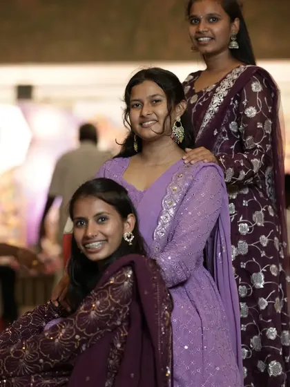 A fun, posed group photo of three young women at an event. I work with guests to create photos they'll love to share.