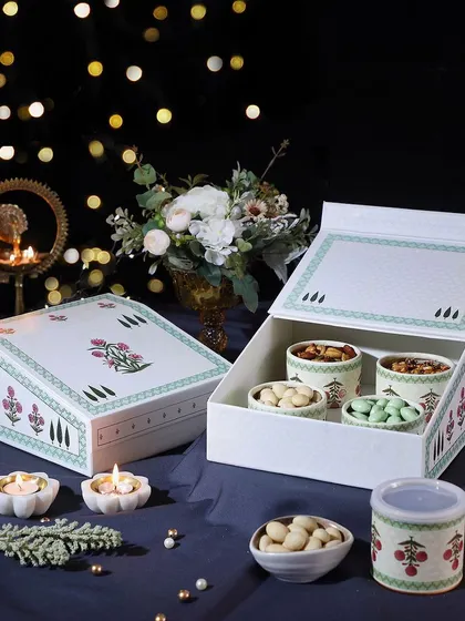 This hamper is a crunchy delight, filled with four types of our premium nuts and cookies: Pista Almonds, Coated Cashews, Mexican Trail Mix, and Mini Butter Cookies.