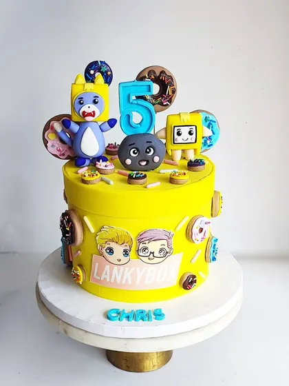 Another view of the Lanky Box cake, showing the colorful donut details and character prints. This cake is completely fondant-free, ensuring it tastes as amazing as it looks.