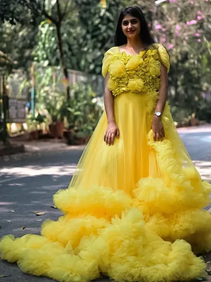 A full-length shot of the yellow ruffle gown, showcasing its beautiful design.