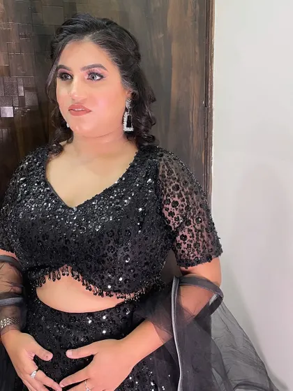 A close-up of the makeup, featuring a soft brown smokey eye and a nude lip, which is a classic combination for any party.