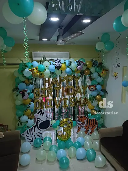 Another angle of the jungle theme home decor, showing how the balloon arrangements and animal props create a fun and wild atmosphere for the birthday celebration.