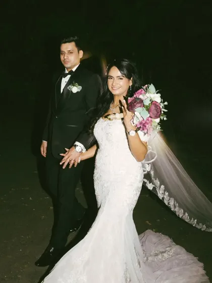 A candid shot of the bride and groom after the ceremony. The bride's peace sign adds a touch of modern fun to this classic wedding portrait.