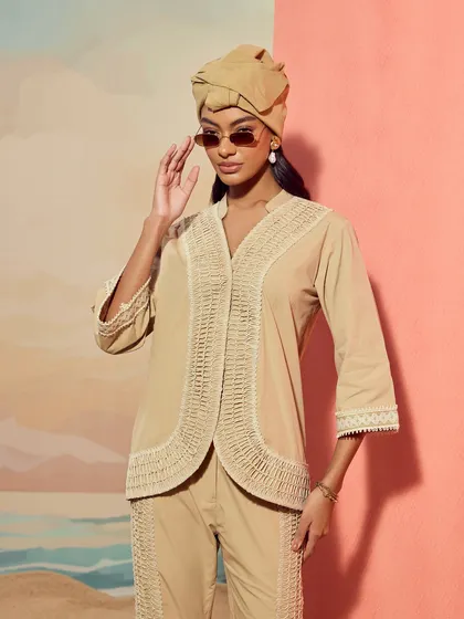 A closer portrait of the Qala Clothing co-ord set, focusing on the intricate lace detailing along the shirt's placket.