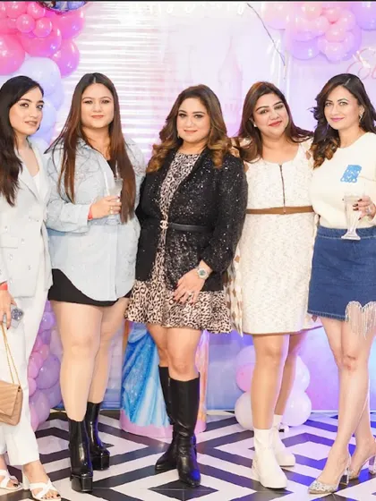 A group of friends enjoying the party and posing for a picture.