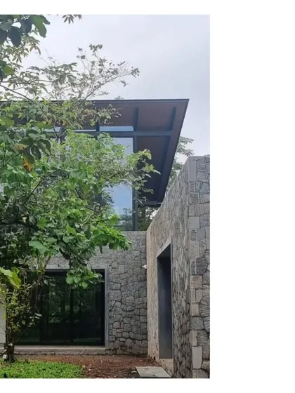 The House in a Grove is an ode to its setting. It is almost impossible to see unless you are within it, a hidden quality we truly enjoy. Here, the stone and glass structure peeks through the trees.