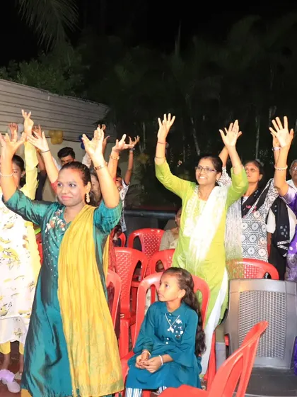 The audience participating in a fun, synchronized activity at a society event.
