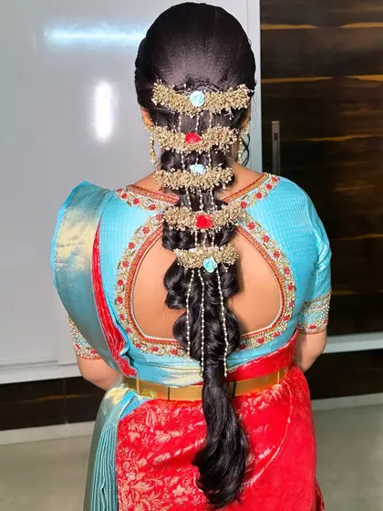 A unique and creative take on a bridal braid, using beaded hair accessories to create a cascading waterfall effect.