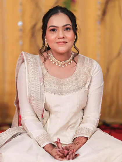 A seated portrait of the guest, looking serene and beautiful with a soft smile.