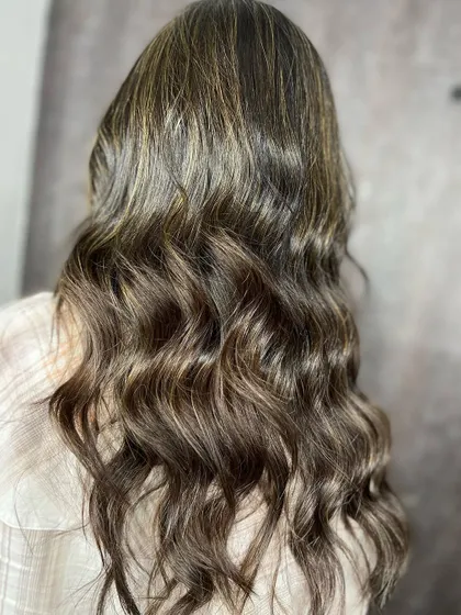 The beautiful result of the ash blonde highlights, styled in loose waves.