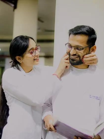 A playful and affectionate moment between the two doctors. Her gentle touch and his happy smile make this a heartwarming and genuine portrait that perfectly captures their dynamic.