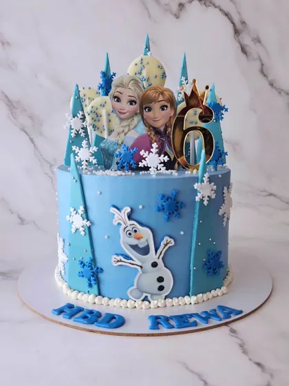 A Frozen cake for Ardra and Reva's 6th birthday. This chocolate mousse cake is a winter wonderland with Elsa, Anna, Olaf, and lots of snowflakes.