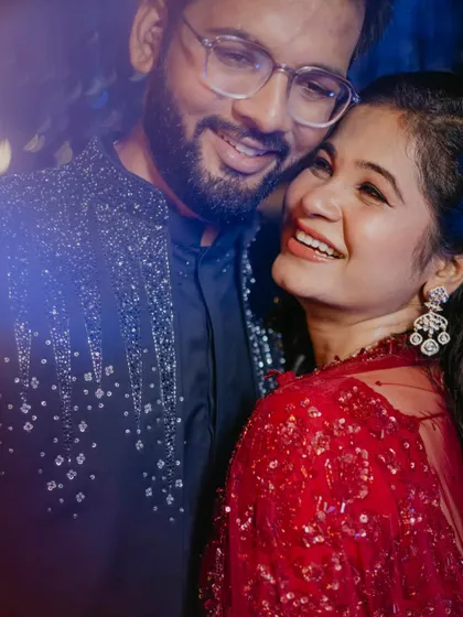A close-up shot filled with genuine happiness. The bride's radiant smile as she looks at her partner captures the pure joy of the Sangeet celebration.
