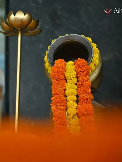 This shot captures the marigold pot alongside a brass lotus lamp, combining two beautiful and traditional decor elements.