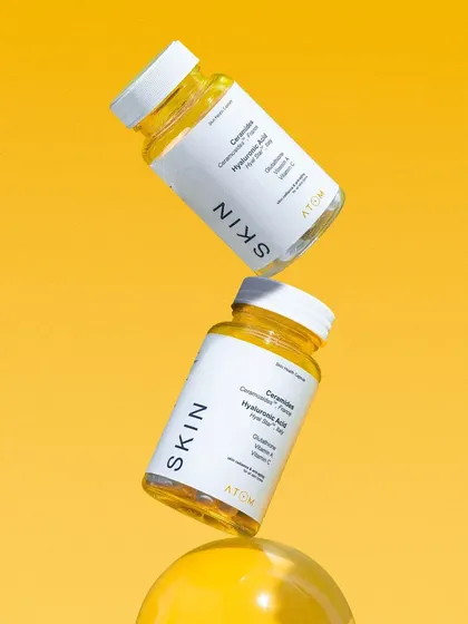 A dynamic, floating composition for Atom Health's "SKIN" supplements. We shot the bottles against a bright yellow background to create a vibrant and energetic image that grabs attention.