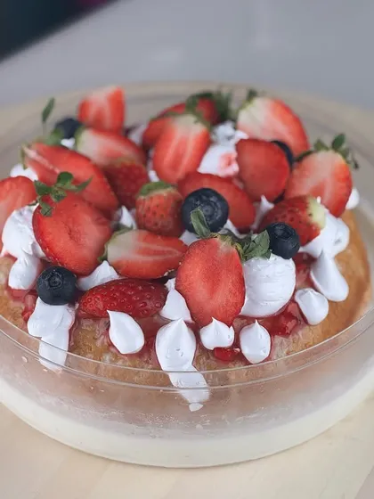 During strawberry season, we swap mangoes for fresh berries. This is our Strawberry Tres Leches cake, topped with a generous amount of fresh strawberries and blueberries.