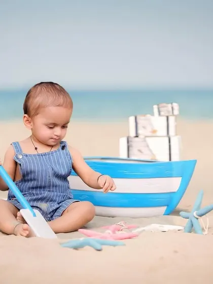 A little explorer digging in the sand. Candid moments of play like this are what make beach photoshoots so special and authentic.