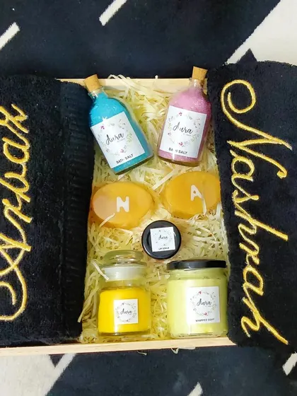 I just love this black and gold theme for a wedding gift. This hamper includes personalized black towels with gold embroidery, vibrant bath salts, and initial soaps for a truly striking and luxurious present.