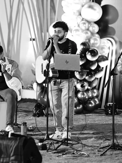 A black and white photo of the band during a performance. This trio setup is versatile, capable of playing everything from soulful ballads to upbeat Bollywood numbers.