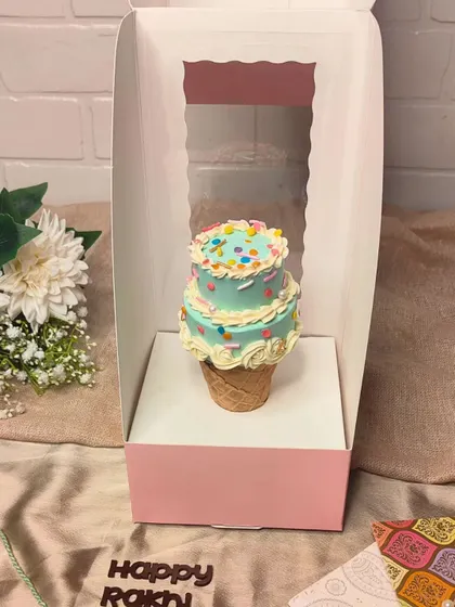 How cute is this Cone Cake? It's a mini two-tiered cake set inside an ice cream cone, decorated with colourful sprinkles. A fun and unique treat for Rakhi.
