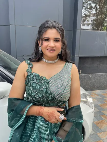 A beautiful look in a unique green and silver lehenga. The makeup is kept soft and pretty to balance the modern, structured outfit.