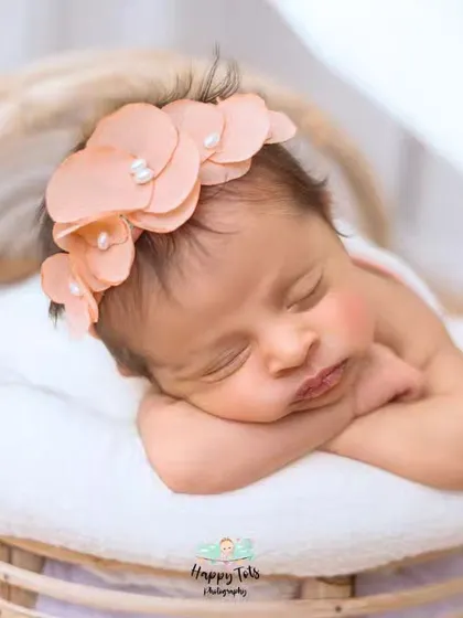 We love using different textures and props. This newborn is nestled in a soft basket with a simple wrap, a classic setup for a timeless newborn photograph.