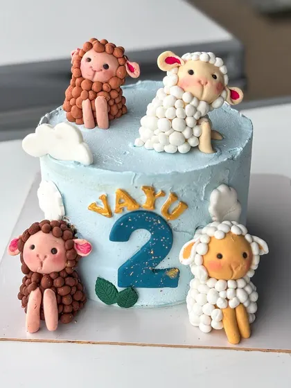 The full view of the sheep cake, with four little fondant friends ready to party.