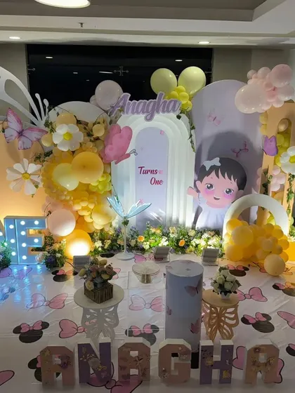 A detailed view of the garden party setup, highlighting the character cutouts and themed floor covering.