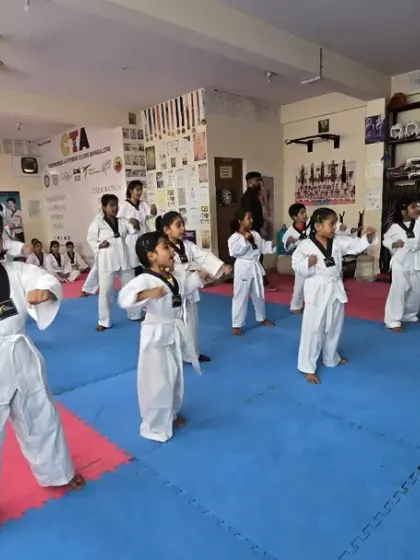 A group of white belts learning the fundamentals of stances and blocks.