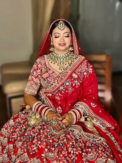 A serene moment before the ceremony. This bride's look features soft, shimmery eyes and a neutral pink lip, a modern take on the classic red bridal style.