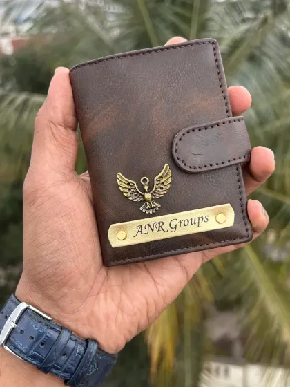 This dark brown faux leather wallet features a custom nameplate and a detailed eagle charm. It's a great example of how a charm can reflect personal style.