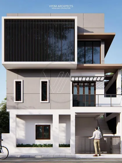 The front elevation of the NRI Layout renovation. This view clearly shows the new floors and how the modern design elements, like the large screened window and open voids, completely transform the original building.