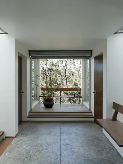 Breakout spaces at the Nirvana Films Studio are designed to feel like extensions of the natural landscape. This small seating nook, framed by a large window, offers a quiet spot for a phone call or a private conversation with an unobstructed view of the trees.