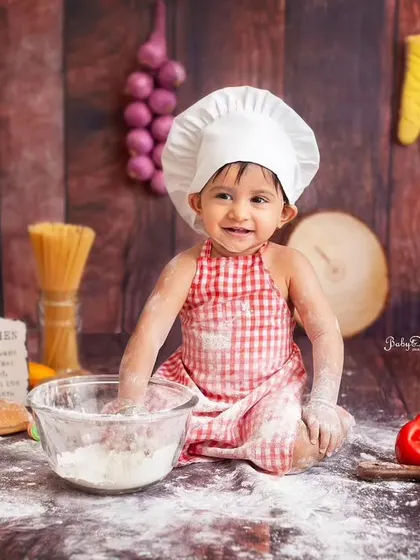 A happy, flour-dusted smile. The messy moments are the best moments in a baby chef or cake smash session.