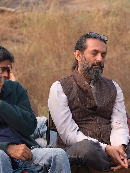 Two audience members in a state of deep meditation during the morning raga performance, showcasing the 'sukoon' our green spaces offer.