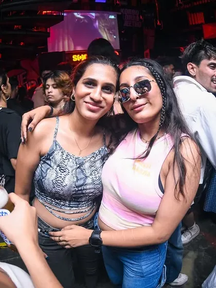 Friends posing for a photo on the dancefloor. Creating memories every Saturday.