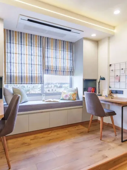 A study room designed for two, with a long bay window seat in the middle providing a cozy spot for reading and relaxation.