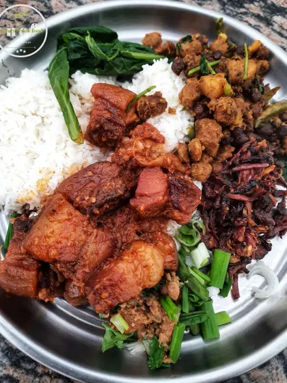 A plate focused on my smoked pork, served with rice and various traditional Manipuri side dishes.