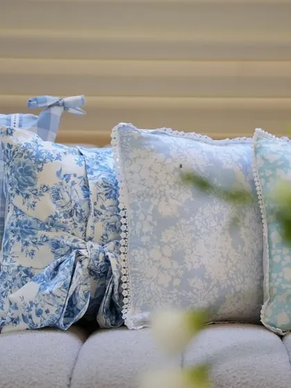 A close-up of the custom-printed pillows in various blue and white patterns.